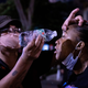 A protester rinses out the eyes of another protester after police fired tear gas during a protest near the White House on Sunday night.